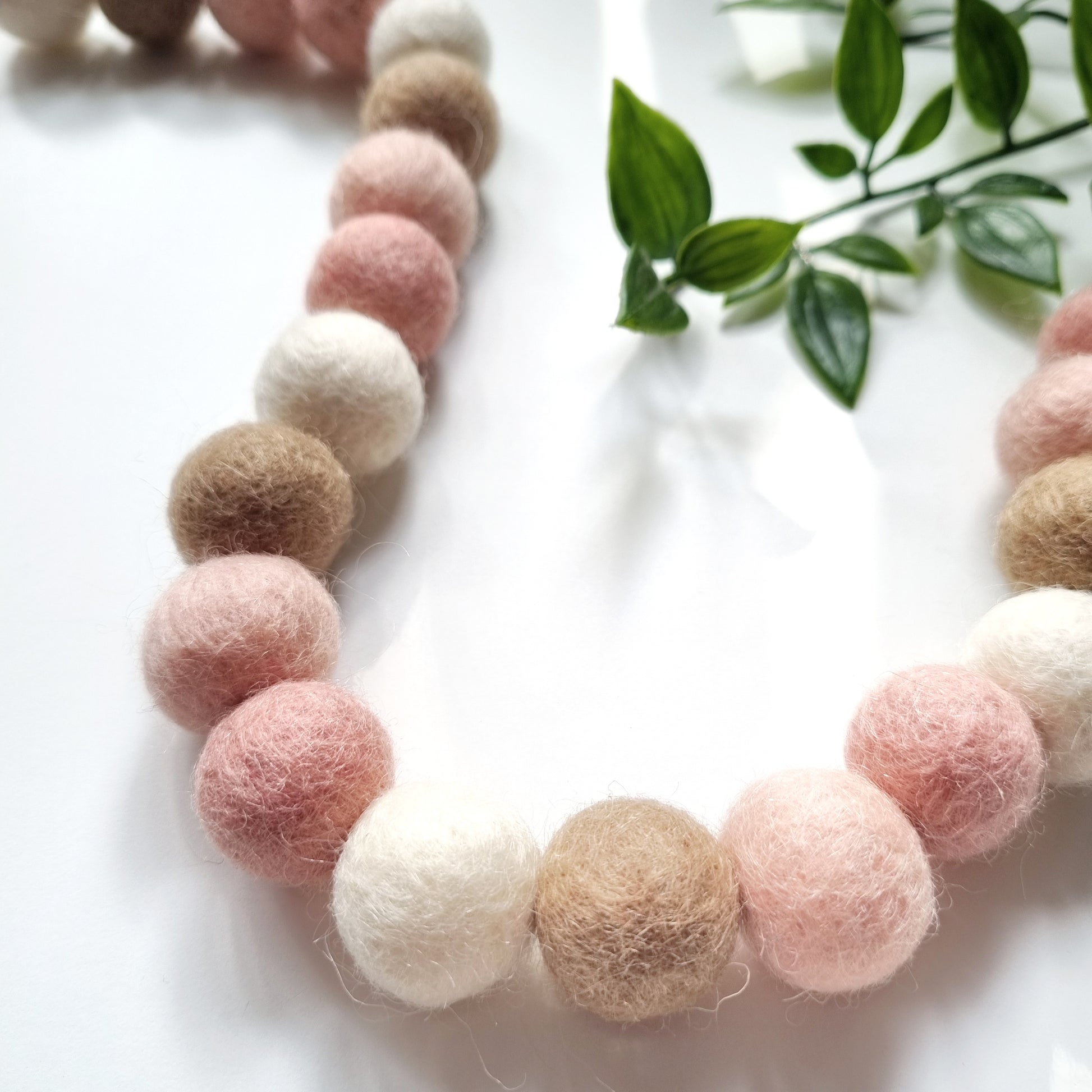 Flat lay of our blush pom pom garland